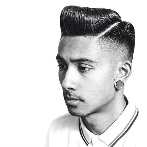 Angled Classic Pompadour Hairstyles - a man with a big earrings and is wearing a polo shirt