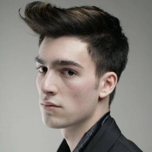 Flat and Brushed Out Pompadour - a man wearing a black polo and a black coat
