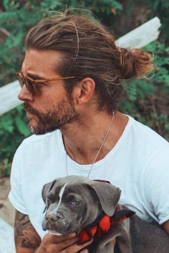 man with man bun and dog 