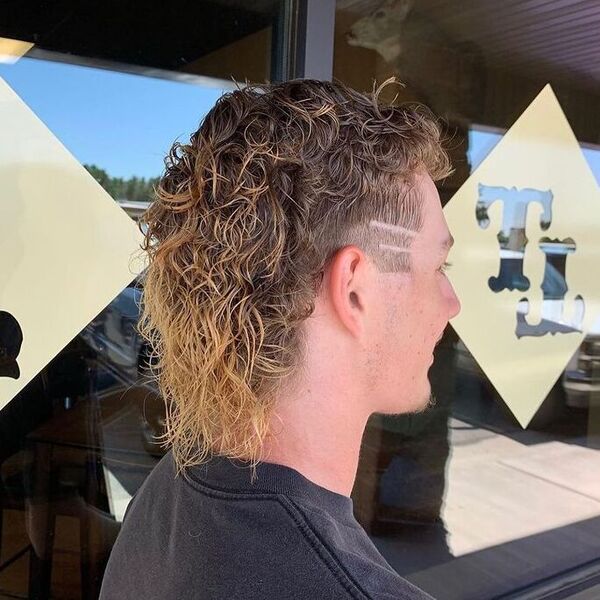Blond Highlights in Permed Mullet Hairstyles - a man wearing black shirt.