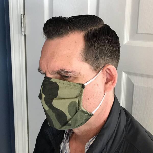 Classic Side Part Haircut - a man wearing an army facemask in a black silk jacket.