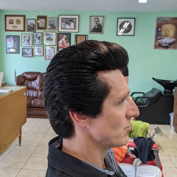 Long Elvis Presley Inspired Ducktail Haircut - a man wearing a black polo.