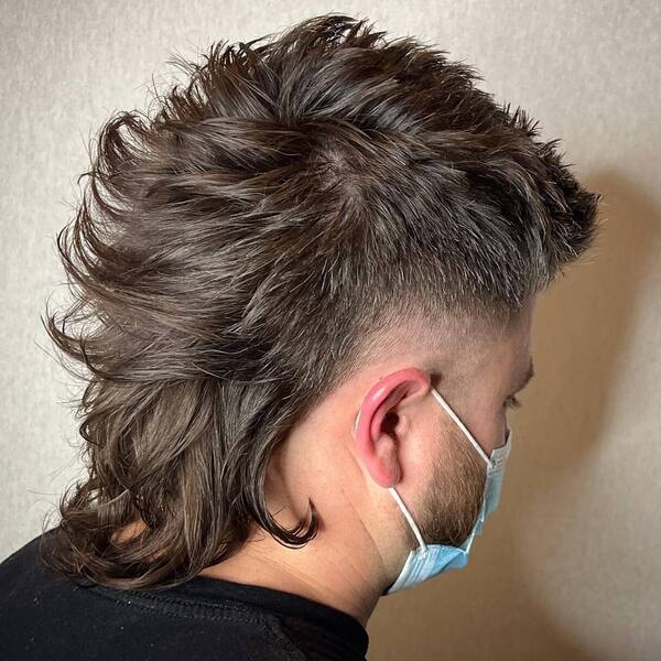 Mullet Rat Tail - a man wearing a surgical mask.