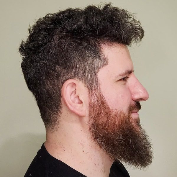 Natural Gray Curl Hair with Trimmed Undercut - a man wearing a black shirt.