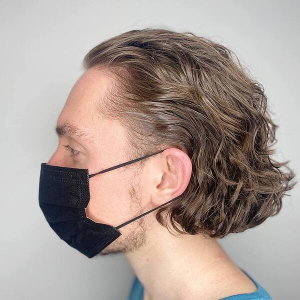Neck-Length Curtain Cut - a man wearing a black mask.