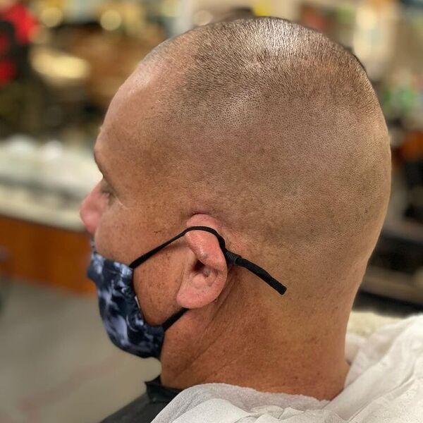 Round Clean Cut Balding Crown Hairstyle - a man wearing colored facial mask.