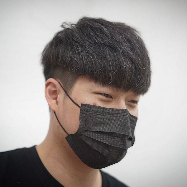 Rounded Two Block Haircut - a man wearing a black facemask and black shirt.