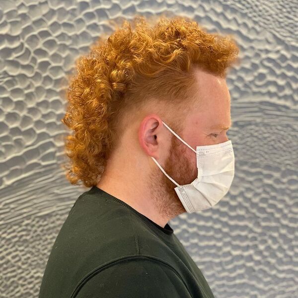 Sunflower Blonde Curl Mullet - a man wearing dark green and a face mask.