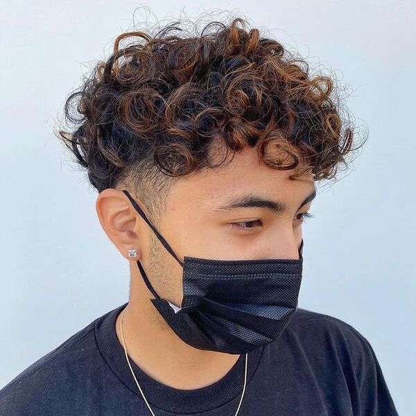 Undercut with Shaggy Curls and Dyed Ends - a man wearing black mask and shirt.