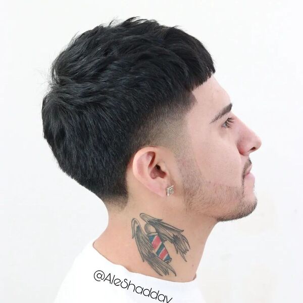 Volumed Edgar Skin Fade - a man with tattoo in his neck and is wearing plain white shirt.