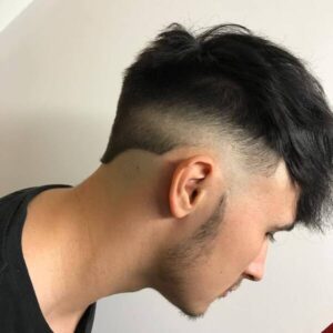 50 Hottest Reverse Fade Hairstyle - a man in a side view wearing a black shirt