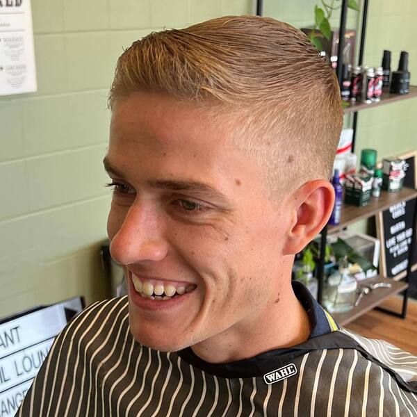 Clean Tidy Hairstyle - a man wearing stripe barber cape.
