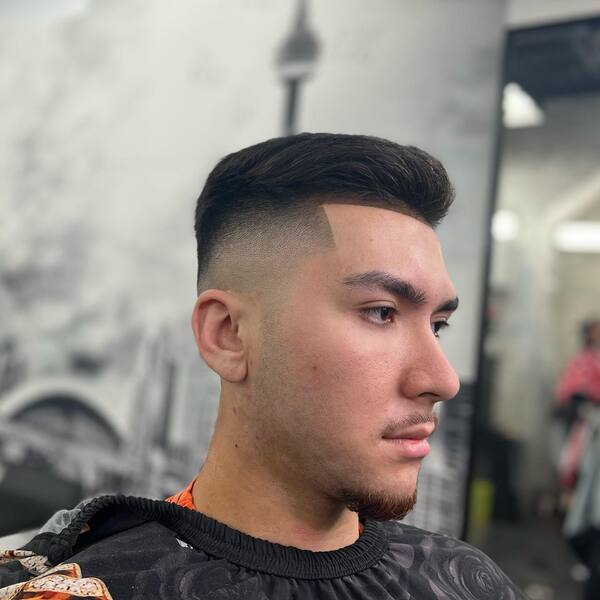 Crew Cut Comb Over with Clean Fade- a man wearing a black barber's cape