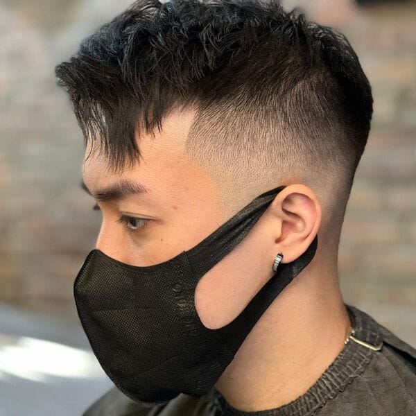 Crew Side Part Skin Fade - a man wearing mask and barber cape.