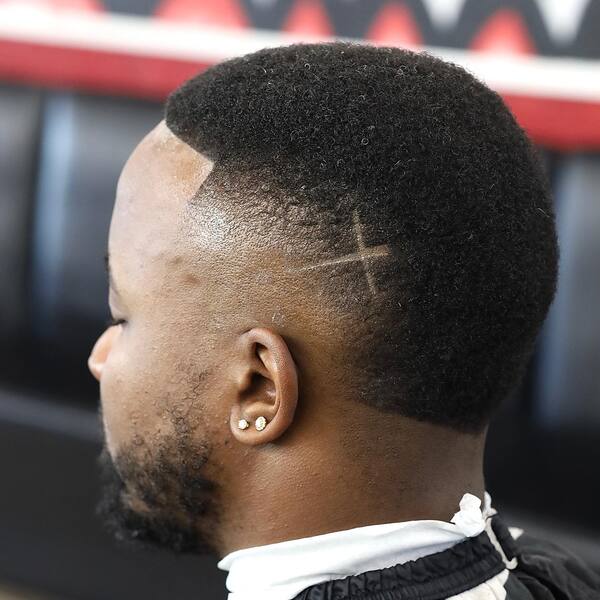 Cross Mark Reverse Fade Hairstyle - a man wearing a black cape