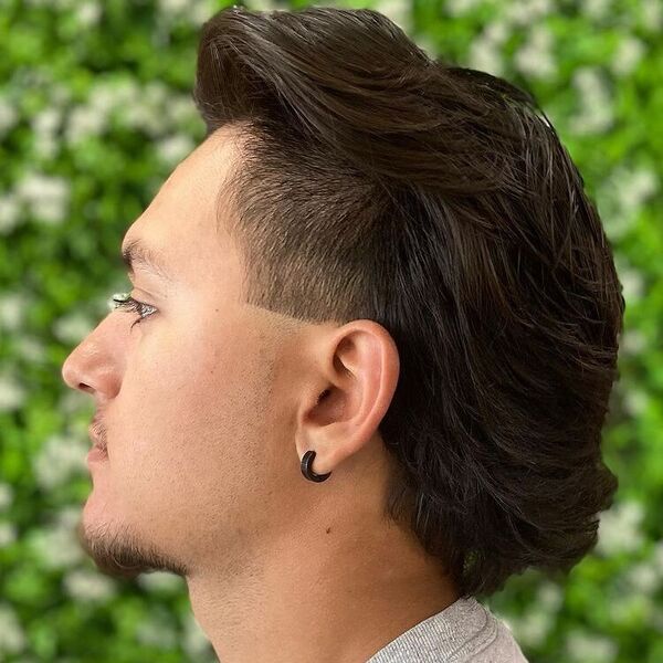Feathered Pomp Mexican Mullet - a man wearing black earring and gray shirt.