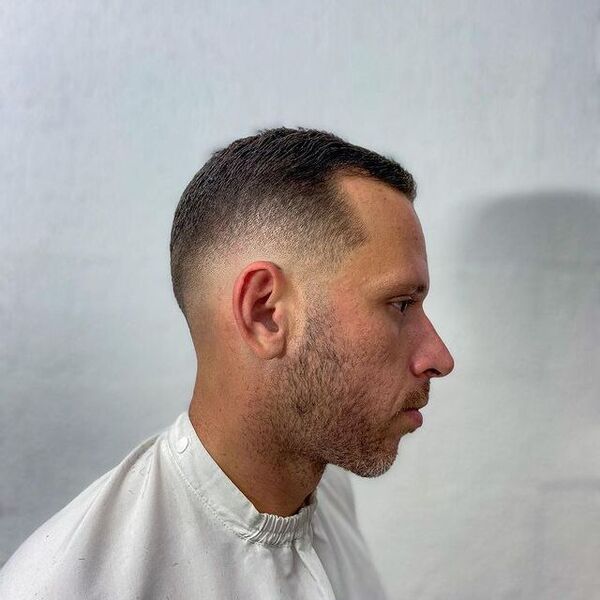 Low Fade Navy Haircut for Men - a man wearing a white shirt