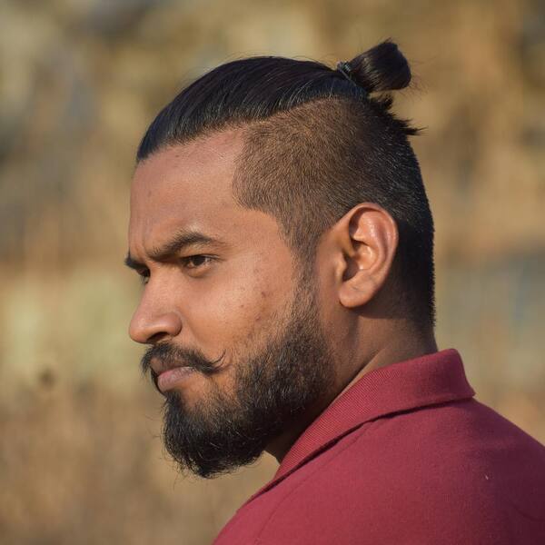 Samurai Knot Fuckboy Haircut - a man wearing a red polo shirt