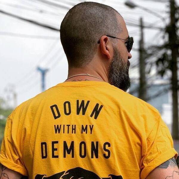 Shaved Head Navy Cut - a man wearing a yellow shirt and sunglasses