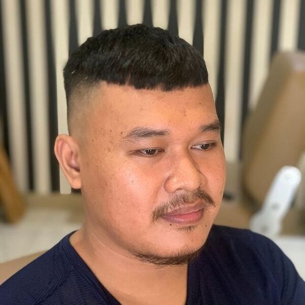 Buzz Trimmed Haircut with Fade - wearing a black shirt