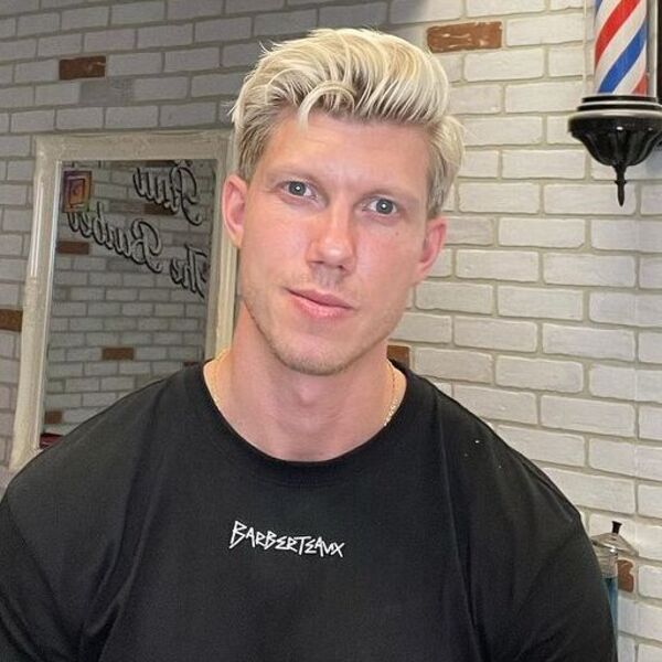 Classic Pompadour Blonde Long Taper Haircut - wearing a black shirt