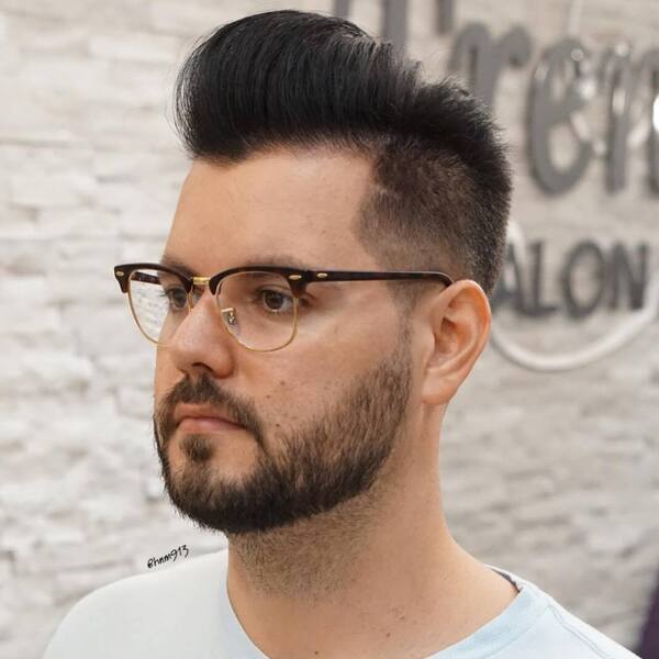 Long Classic Pomp Cut with Fury Hairstyle - a man wearing an eyeglasses