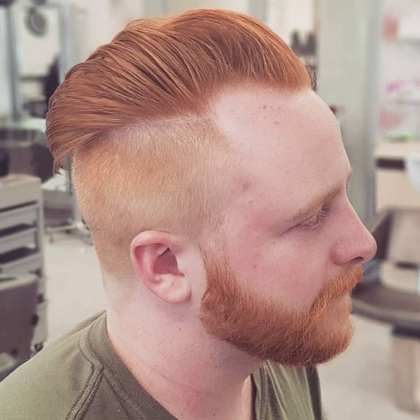 Pompadour Copper Shade with Fury Hairstyle - a man wearing a green shirt