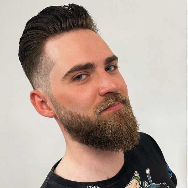 Texture Long Pomp Haircut with Fury Hairstyle - a man wearing a black printed shirt