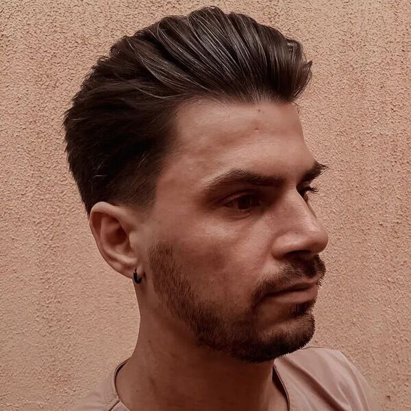 Textured Long Pomp Cut - a man wearing a small black earring