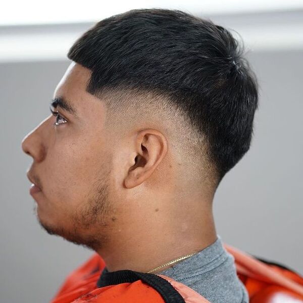 Trimmed Buzz Haircut with Fade - wearing a gold chain necklace