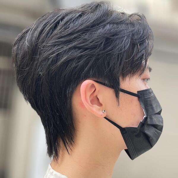 wearing black facemask with small earring - layered haircuts for men
