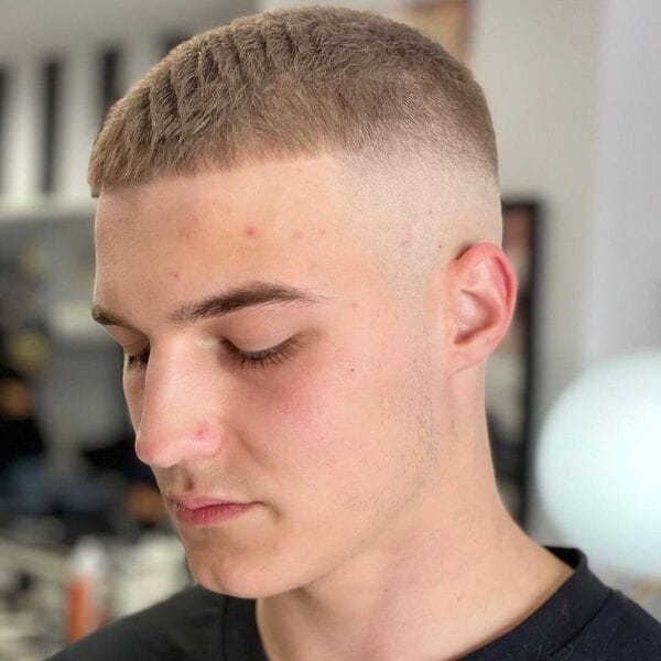 Clean Buzz Haircut with Light Brown Shade - wearing v neck plain black shirt