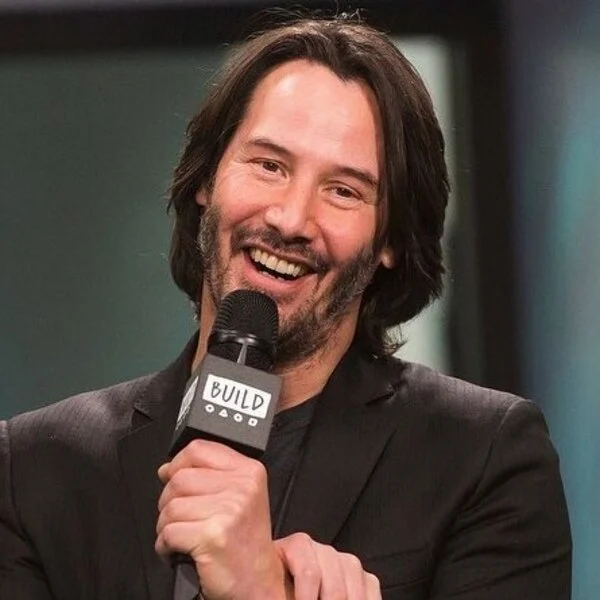 Keanu Reeves Hairstyle Middle Part Hairstyle with Edgy Cut - wearing dark brown tuxedo