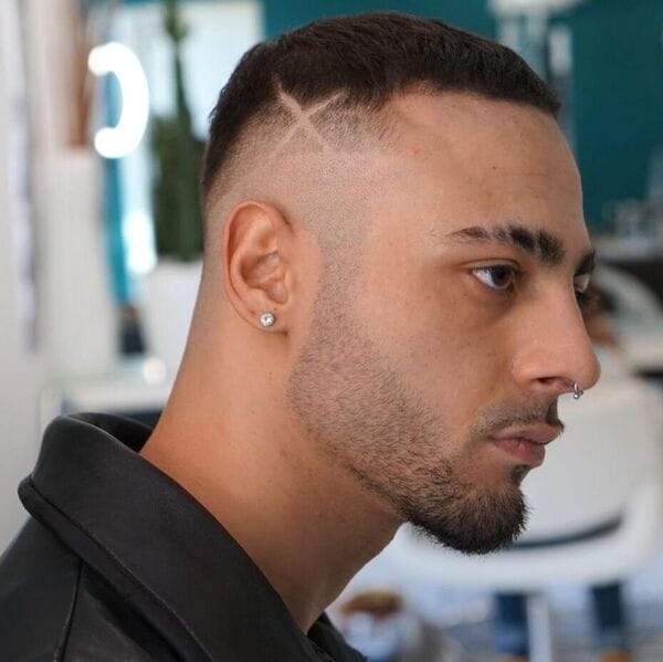 Mohawk Hair Taper Style with Artsy Side Cut - has piercing on his nose