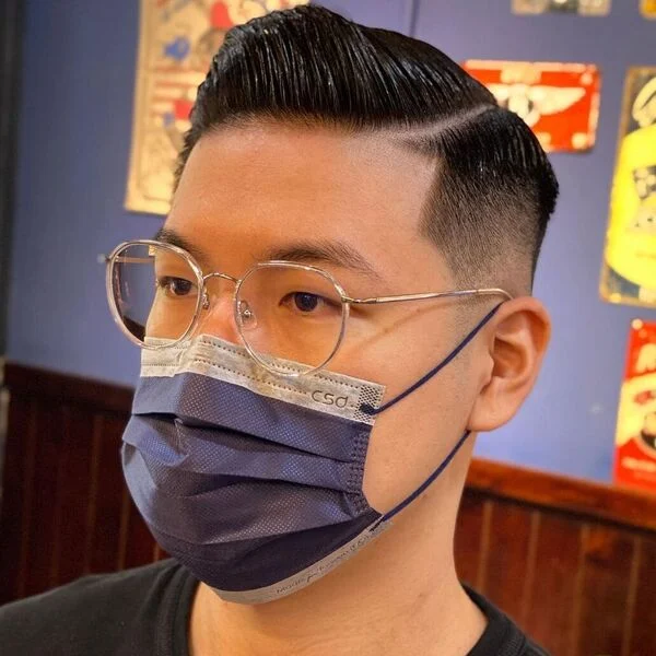 a man wearing sunglasses and a facemask has one of the best summer haircut for men