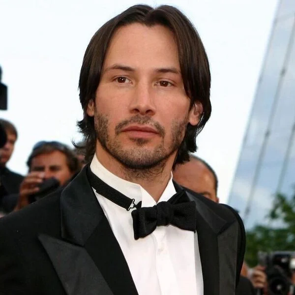 Keanu Reeves Hairstyle Two Parted Straight Hairstyle with Curvy Ends - wearing formal tuxedo