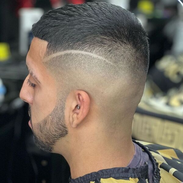 A man wearing haircut cover with piercing on his ear