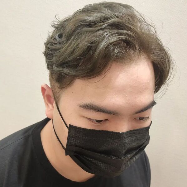 A man wearing a black facemask and a black shirt